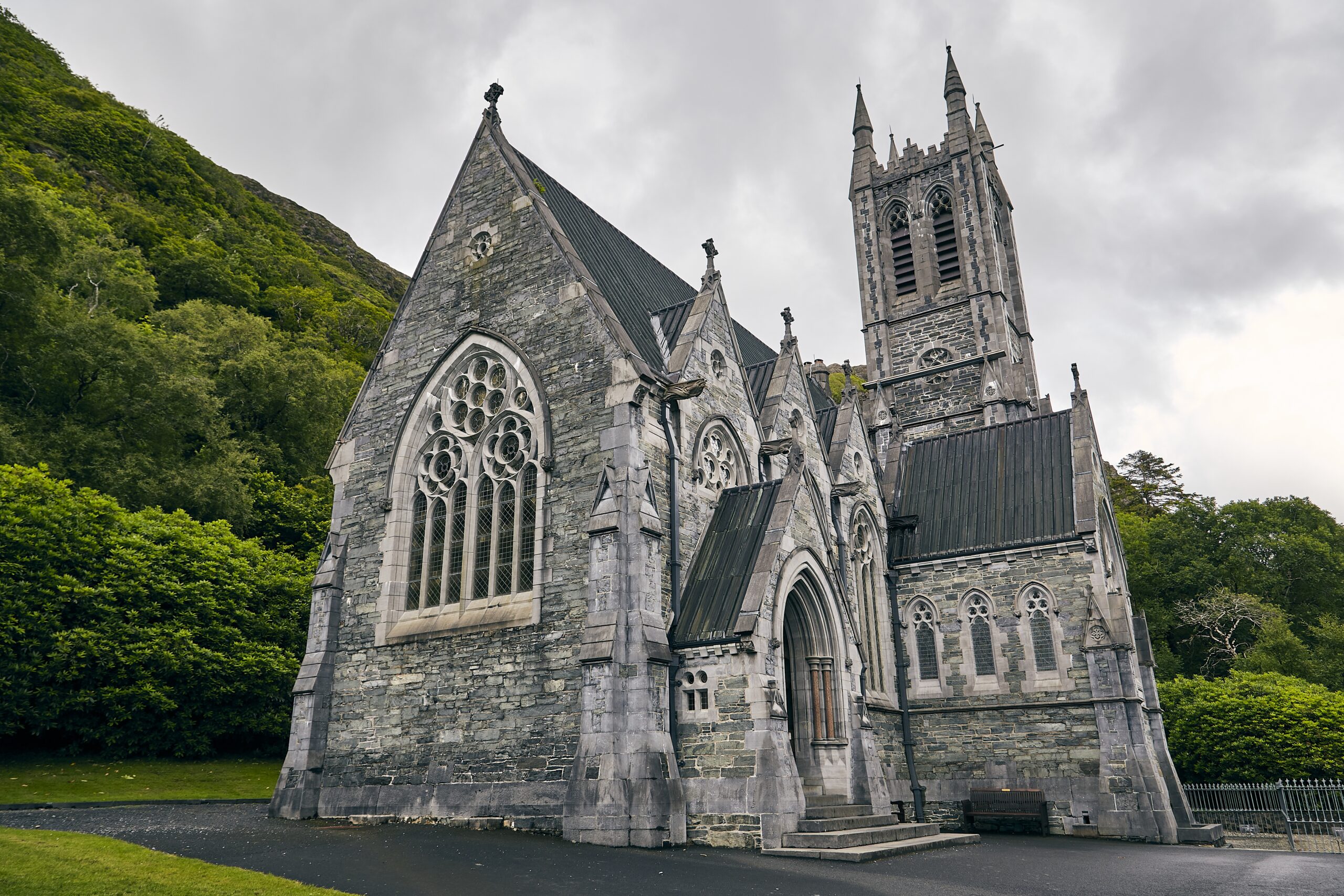 A low angle shot of Kylemore Abbey in Ireland surrounded by greenery